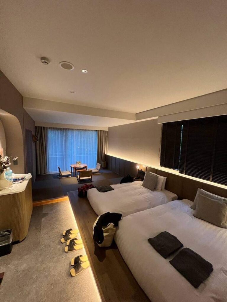 Two beds and a tatami sitting area in our member-allocated room at nol hakone myojindai
